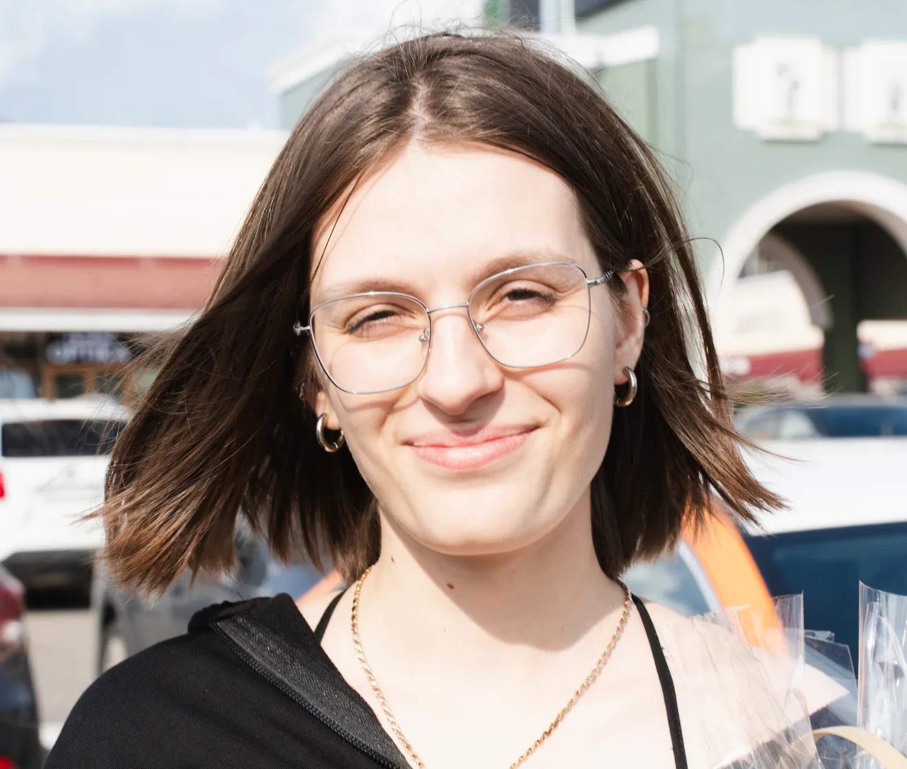 Evoto before example of an outdoor portrait with glasses and squinting eyes